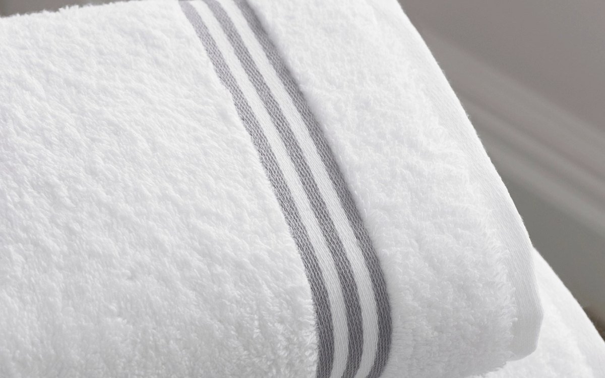 Neatly folded clean towels in a senior living laundry room